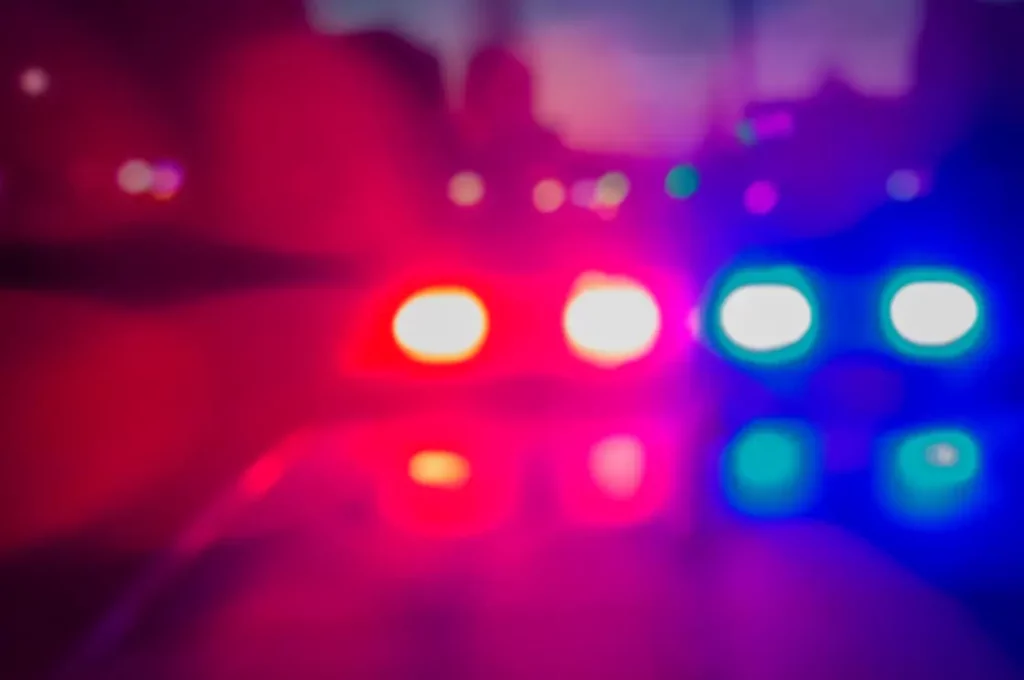 Unfocused red and blue sirens on top of an emergency car